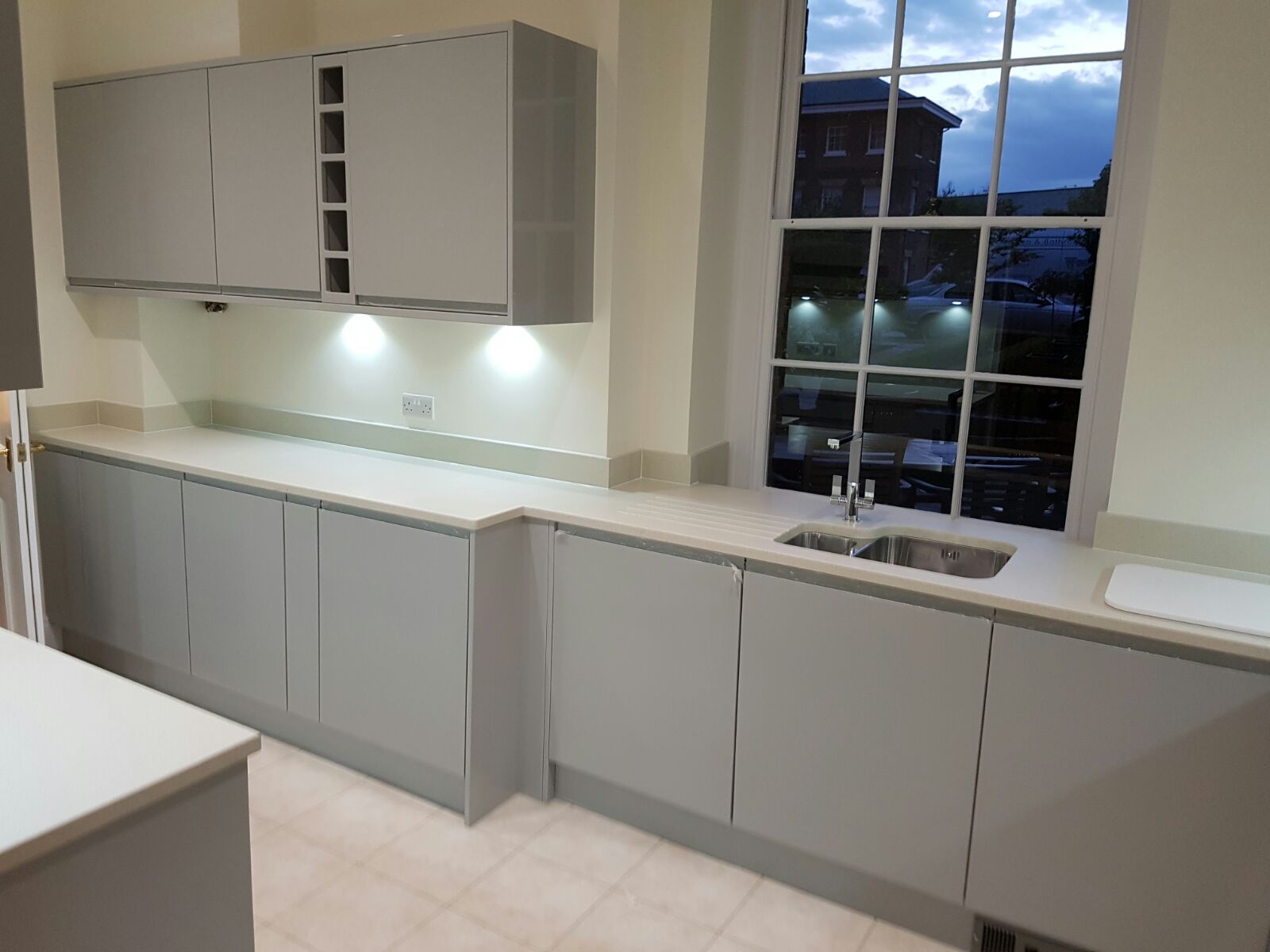 Completed modern grey handleless kitchen by Woods and Sons