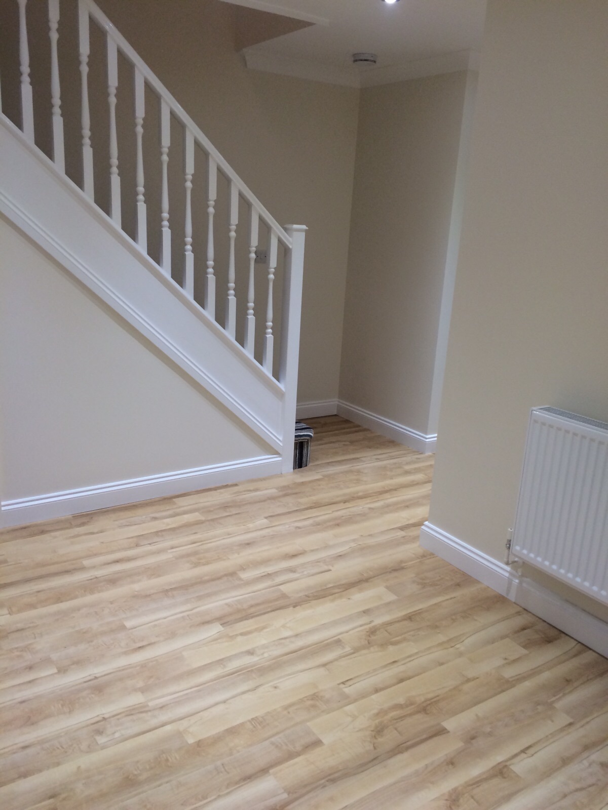 Completed hallway, staircase and fitted wood-effect flooring